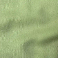 Close-up of Longan Craft's Solid Color Denim Lyocell Fabric By The Yard, featuring a light green, wrinkle-free twill weave with subtle folds. This breathable and comfy lyocell textile is ideal for jeans and other stylish creations.