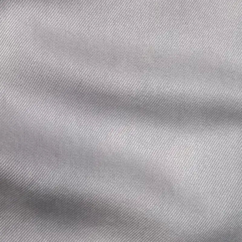 Close-up of Longan Craft's Solid Color Denim Lyocell Fabric By The Yard, a wrinkle-free, breathable, and comfy material with a subtle diagonal weave—ideal for sustainable jeans and eco-friendly fashion projects.