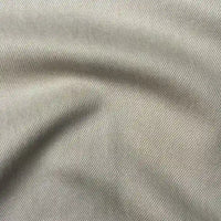 Close-up of Longan Craft’s Solid Color Denim Lyocell Fabric by the yard, showing fine diagonal lines and subtle folds. This breathable, comfy, wrinkle-free material is ideal for sustainable fashion and perfect for jeans.