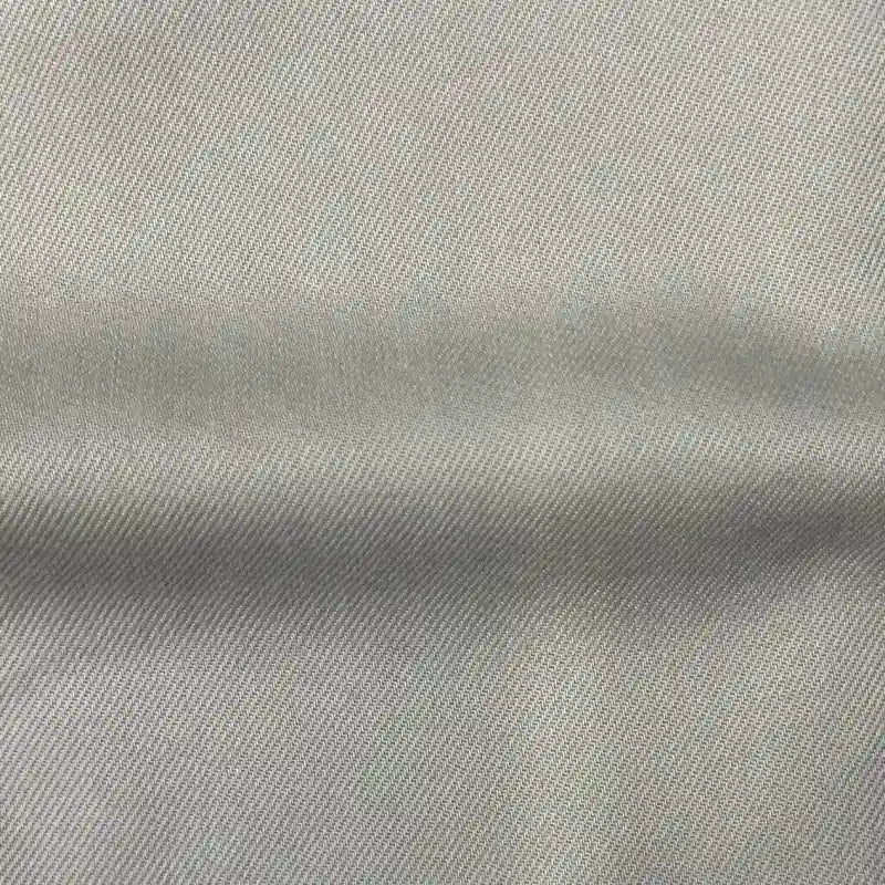 Close-up of Longan Craft's Solid Color Denim Lyocell Fabric, a breathable, wrinkle-free material with a subtle diagonal weave—ideal for comfy, sustainable jeans and fashion projects by the yard.