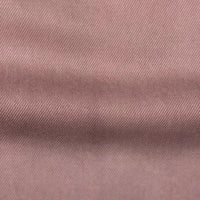 Close-up of Longan Craft’s Solid Color Denim Lyocell Fabric by the Yard, featuring a pinkish-brown hue, subtle diagonal weave, and gentle horizontal fold—this wrinkle-free, breathable, and comfy material is ideal for sustainable jeans.