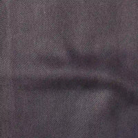 Close-up of Longan Craft’s Solid Color Denim Lyocell Fabric by the yard, showcasing its dark gray color, subtle diagonal ribbed texture, and faint crease. This breathable, wrinkle-free material is perfect for comfy jeans and more.