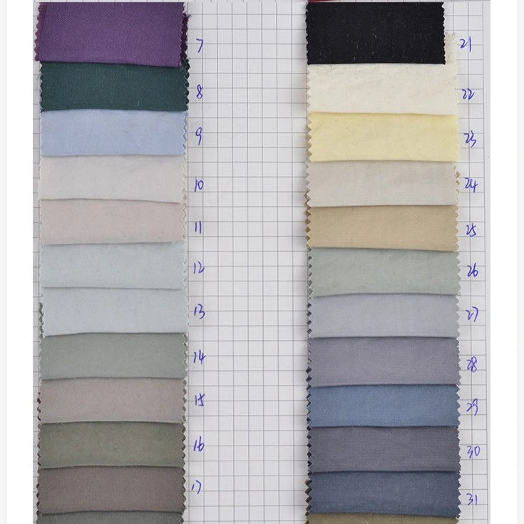Two columns of hand-numbered Solid Color Double Sided Peachskin Fabric swatches by Longan Craft are shown on grid paper, displaying microfiber polyester hues from purple and green to beige, cream, and black.