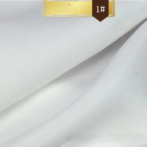 Close-up of Solid Color Linen Lyocell Fabric By The Yard from Longan Craft, showing smooth, wrinkle-free twill lyocell material with soft folds. A gold label and a brown tag marked "1#" are visible at the top edge.