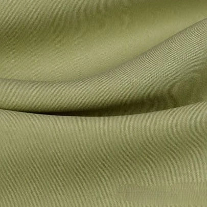 A close-up of Longan Craft's Solid Color Linen Lyocell Fabric By The Yard reveals light olive green, wrinkle-free twill lyocell with a soft texture, gentle folds, and a fine weave—sustainable and breathable for dresses.