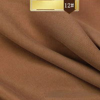 A close-up of light brown Solid Color Linen Lyocell Fabric by Longan Craft shows a fine twill weave and soft folds. A gold-brown label with code 12# highlights this sustainable, breathable, and wrinkle-free material for dresses.