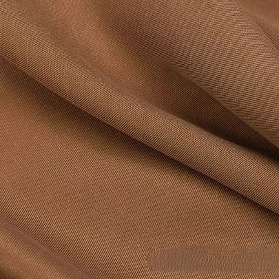 Close-up of Longan Craft Solid Color Linen Lyocell Fabric by the Yard, featuring a brown wrinkle-free twill weave with smooth texture and gentle folds—sustainable and breathable material perfect for dresses.