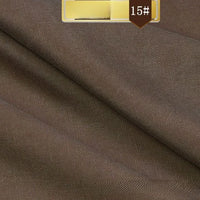 Close-up of brown Solid Color Linen Lyocell Fabric by Longan Craft, featuring a subtle twill texture. A gold label with 15# appears on a brown badge at the top. Sustainable, breathable, and wrinkle-free—ideal for dresses.