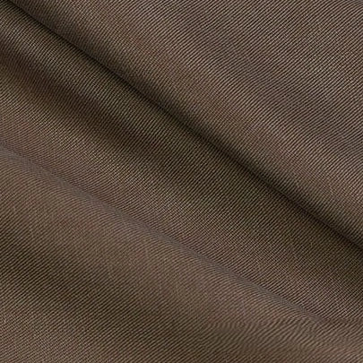 Close-up of Longan Craft’s Solid Color Linen Lyocell Fabric By The Yard shows its diagonal twill rib, visible texture, and fold lines, highlighting the sustainable, wrinkle-free material ideal for breathable dresses.