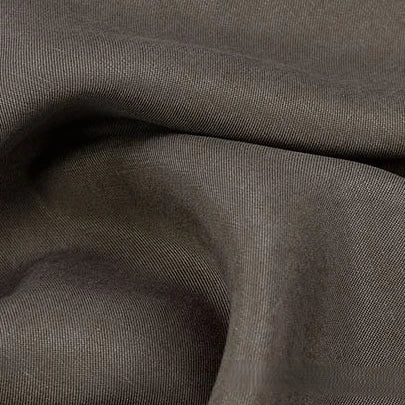 A close-up of Longan Craft’s Solid Color Linen Lyocell Fabric by the yard in brownish-gray, showing gentle folds and soft shadows that highlight its smooth, wrinkle-free twill surface—ideal for sustainable, breathable dresses.
