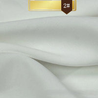 A close-up of Longan Craft's Solid Color Linen Lyocell Fabric shows its smooth, white, sustainable material with soft folds. At the top, a gold label marked 2# is displayed.