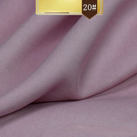 A close-up of Longan Craft’s Solid Color Linen Lyocell Fabric By The Yard with a fine, smooth texture. The sustainable, wrinkle-free twill Lyocell material is softly draped. A gold and brown label marked 20# appears in the top corner.