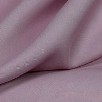 Close-up of Longan Craft’s Solid Color Linen Lyocell Fabric by the yard, featuring a soft light mauve hue, smooth wrinkle-free twill texture, gentle folds, and subtle sheen—sustainable and breathable for dresses.
