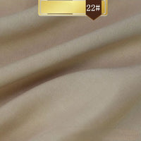 Close-up of Longan Craft's Solid Color Linen Lyocell Fabric By The Yard in light beige with soft diagonal folds and a gold "22#" label. This wrinkle-free, smooth, and sustainable lyocell twill is ideal for dresses.