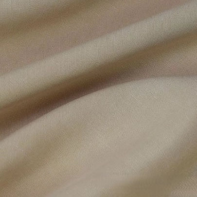 A close-up of Longan Craft’s Solid Color Linen Lyocell Fabric By The Yard shows its light beige wrinkle-free twill, soft folds, smooth texture, and subtle weave—sustainable, breathable lyocell textile perfect for dresses.