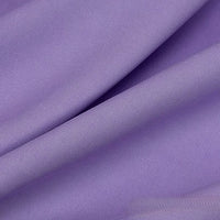 Close-up of Longan Craft’s Solid Color Linen Lyocell Fabric by the Yard—a wrinkle-free, lilac twill lyocell textile with visible diagonal folds and a soft, smooth texture, ideal for sustainable and breathable dresses.
