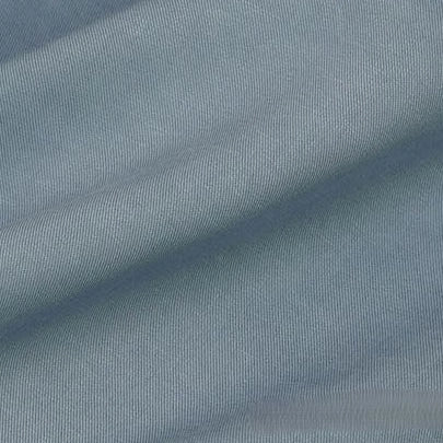 Close-up of Longan Craft’s Solid Color Linen Lyocell Fabric By The Yard, a sustainable wrinkle-free twill material in light blue, showing its diagonal weave, soft folds, and breathable texture—ideal for dresses.
