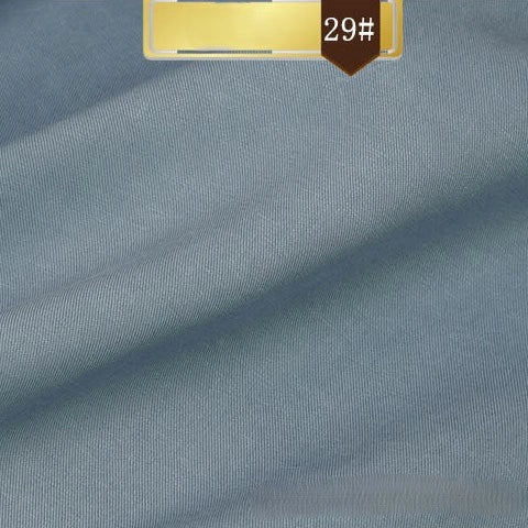 Light blue Solid Color Linen Lyocell Fabric by Longan Craft—wrinkle-free, breathable twill with a fine texture and subtle diagonal lines. A gold "29#" label stands out on a brown background. Ideal for dresses and sustainable fashion projects.