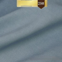 Light blue Solid Color Linen Lyocell Fabric by Longan Craft—wrinkle-free, breathable twill with a fine texture and subtle diagonal lines. A gold "29#" label stands out on a brown background. Ideal for dresses and sustainable fashion projects.