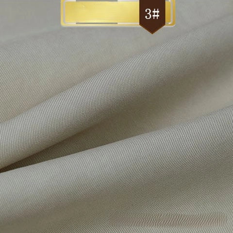 Close-up of Longan Craft's Solid Color Linen Lyocell Fabric By The Yard, a wrinkle-free, sustainable twill material. The smooth, light gray or beige textile is soft and breathable—ideal for dresses. A brown and yellow 3# label is visible at the top.