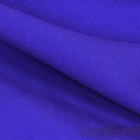 Close-up of Longan Craft's Solid Color Linen Lyocell Fabric by the yard, a wrinkle-free twill lyocell material in royal blue with a smooth texture, diagonal weave, and gentle folds—sustainable, breathable, and ideal for dresses.