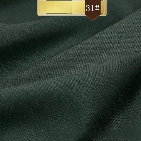 Solid Color Linen Lyocell Fabric by Longan Craft shown in dark green with a smooth finish and gentle folds. Labeled 31# on a brown tab, this sustainable, wrinkle-free twill is ideal for breathable, elegant dresses and durable projects.