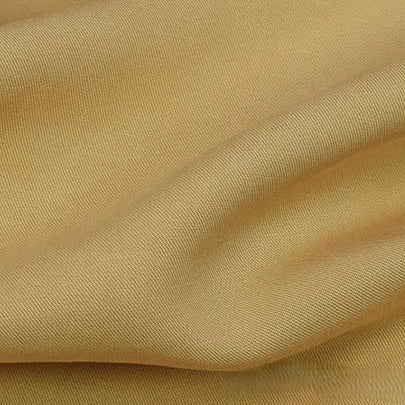 Close-up of Longan Craft's Solid Color Linen Lyocell Fabric by the Yard reveals a visible twill weave and gentle folds, showcasing its soft, smooth look. This sustainable, wrinkle-free fabric is breathable—ideal for dresses.