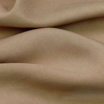 A close-up of Longan Craft's Solid Color Linen Lyocell Fabric By The Yard shows smooth, soft folds and a subtle diagonal weave, highlighting this sustainable, wrinkle-free twill material perfect for breathable dresses.