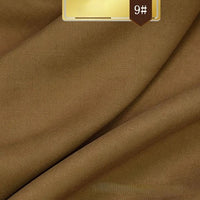 Close-up of smooth, brown Solid Color Linen Lyocell Fabric by Longan Craft, featuring fine texture and soft folds. A golden label with "9#" appears in the top right corner; ideal for dresses with sustainable, wrinkle-free lyocell material.