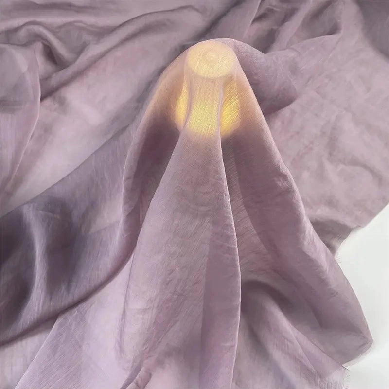 A round light glows under Longan Craft’s Solid Color Linen Silk Fabric by the yard, a sheer lyocell-silk blend that creates soft folds and a gentle, luxurious ambiance—ideal for silk upholstery and decor projects.