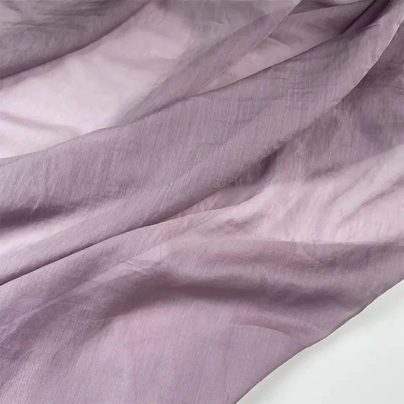 A close-up of Longan Craft’s Solid Color Linen Silk Fabric By The Yard shows its thin Lyocell silk blend with graceful folds and shadows, highlighting the delicate, airy quality that makes it perfect for upholstery and luxurious projects.