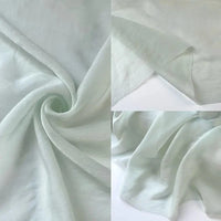A collage of three close-ups showcases Longan Craft’s Solid Color Linen Silk Fabric By The Yard— a thin lyocell silk blend — highlighting its smooth texture, soft pale green hue, gentle folds, and lightweight drape.