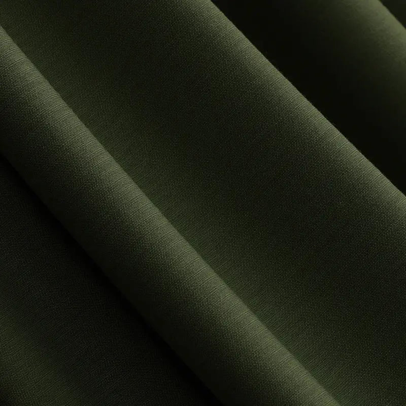 Close-up of dark green Solid Color Modal Jersey Fabric by Longan Craft, featuring a fine, smooth texture and subtle sheen. This breathable cotton spandex jersey textile is ideal for children's clothing and sleepwear. Sold by the yard.