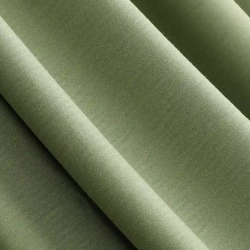 Close-up of olive green Solid Color Modal Jersey Fabric by the yard from Longan Craft, showing soft folds and subtle herringbone texture. This cotton spandex jersey textile is breathable and ideal for comfortable sleepwear.