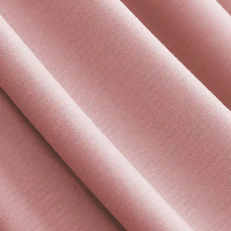 Close-up of Longan Craft’s Solid Color Modal Jersey Fabric By The Yard, a soft, light pink cotton spandex textile with a smooth texture—ideal breathable jersey for sleepwear thanks to its fine weave and gentle drape.