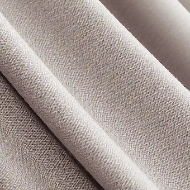 Close-up of Longan Craft Solid Color Modal Jersey Fabric by the Yard, a soft, breathable cotton spandex jersey textile in light beige with gentle folds and a smooth, slightly textured surface—ideal for sleepwear.
