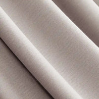 Close-up of Longan Craft Solid Color Modal Jersey Fabric by the Yard, a soft, breathable cotton spandex jersey textile in light beige with gentle folds and a smooth, slightly textured surface—ideal for sleepwear.