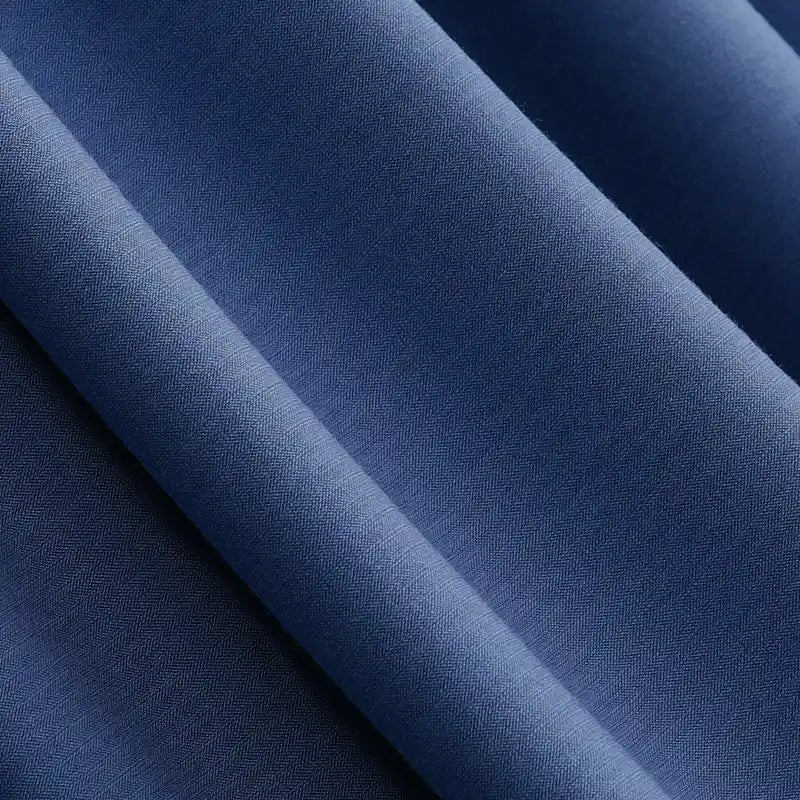 Close-up of smooth, folded Solid Color Modal Jersey Fabric by Longan Craft in navy blue, showing its soft texture, subtle sheen, and diagonal folds—ideal breathable cotton spandex jersey textile for sleepwear.
