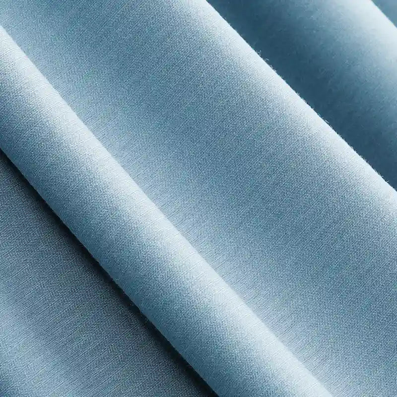 Close-up of Longan Craft Solid Color Modal Jersey Fabric By The Yard, a light blue cotton spandex jersey textile with smooth diagonal folds, soft texture, and subtle sheen—ideal for breathable sleepwear.
