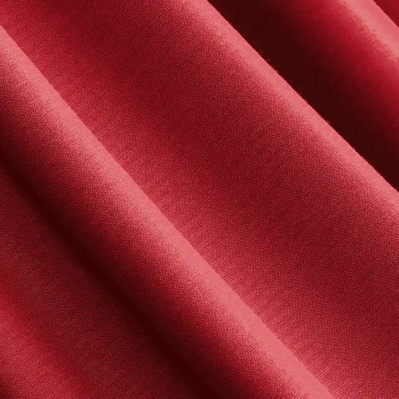Close-up of deep red Solid Color Modal Jersey Fabric by Longan Craft, featuring a smooth texture and diagonal folds. This cotton spandex jersey is breathable and ideal for sleepwear. Available by the yard.