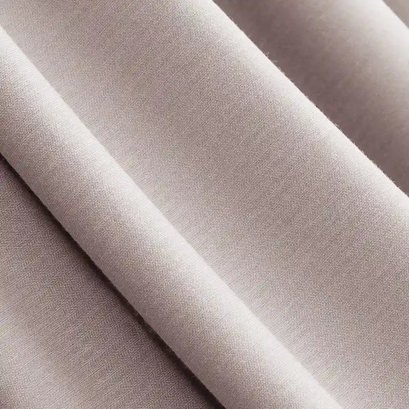 Close-up of Longan Craft’s Solid Color Modal Jersey Fabric by the Yard, a soft, light beige cotton spandex jersey with smooth texture and subtle sheen—ideal breathable textile for comfortable sleepwear creations.
