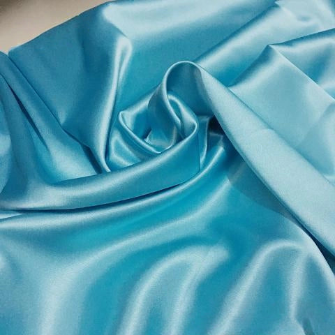 Longan Craft’s Solid Color Polyester Satin Fabric By The Yard features a silky stretch satin texture in light blue, creating a smooth, luxurious look with soft drape and gentle sheen—ideal for stylish blouses.