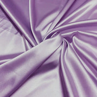 Longan Craft Solid Color Polyester Satin Fabric by the yard features silky stretch satin texture in solid lavender, perfect for making blouses. Its smooth, shiny finish creates a luxurious and glossy look with gentle drapes.