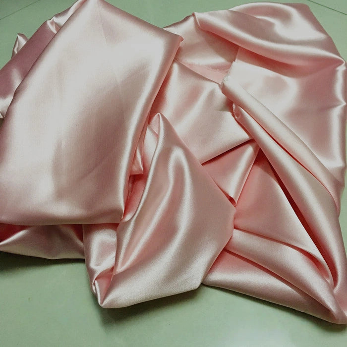 A close-up of Longan Craft’s Solid Color Polyester Satin Fabric by the yard shows its silky stretch texture and glossy, soft surface—ideal satin material for blouses.