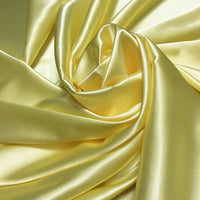 A close-up of Longan Craft’s Solid Color Polyester Satin Fabric by the yard, elegantly draped to highlight its silky stretch texture, shiny surface, and soft flow—ideal satin material for blouses.