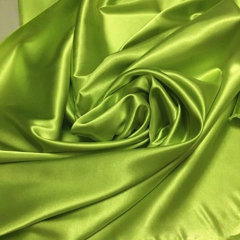 Longan Craft's Solid Color Polyester Satin Fabric by the yard features a lime green, silky stretch satin texture with glossy reflections—perfect material for blouses, beautifully arranged in gentle folds and swirls.