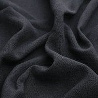 Close-up of Longan Craft Solid Color Rayon Linen Fabric By The Yard, a thick, washed slub viscose material with gentle folds and a soft, textured surface—ideal for dresses and clothing.