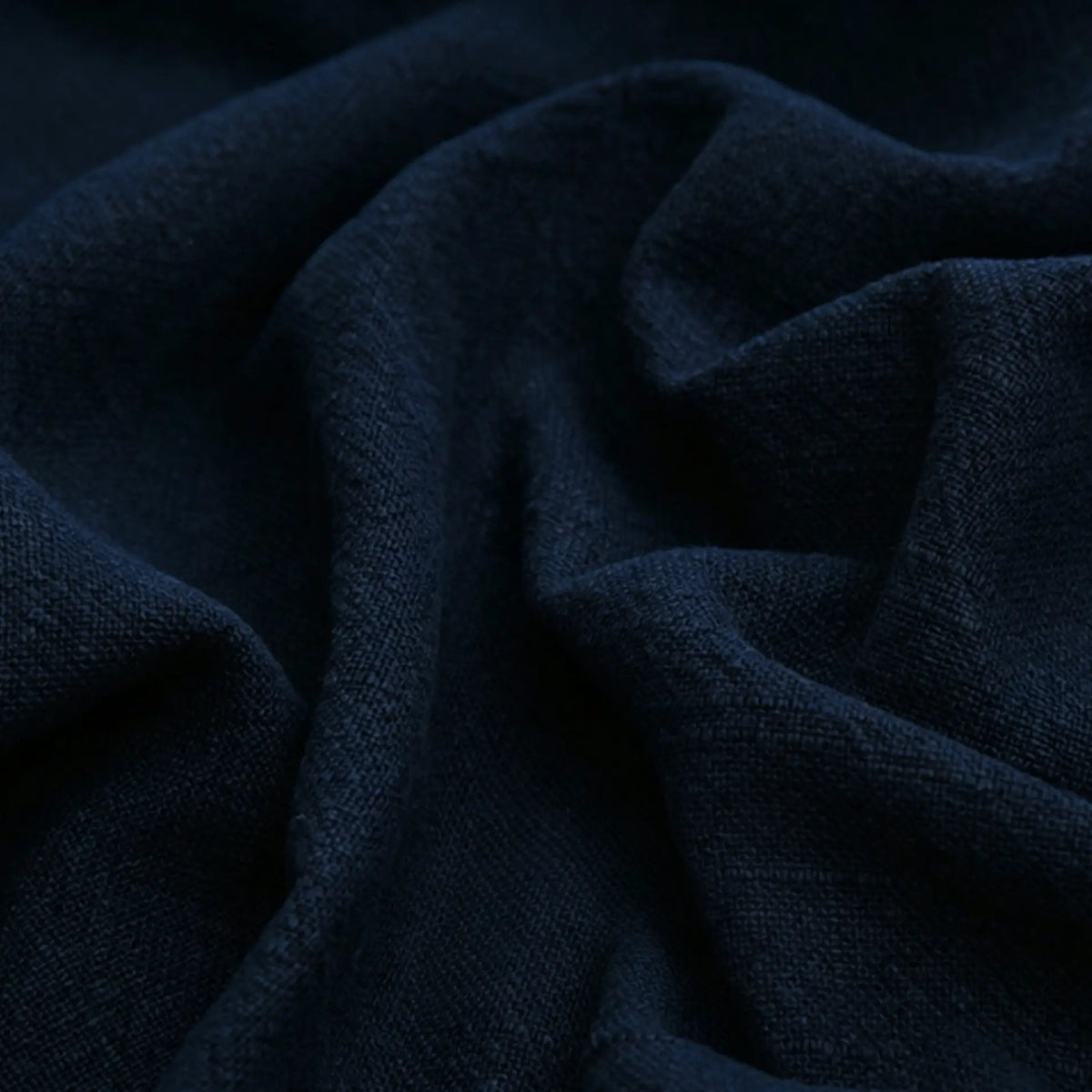 Close-up of Longan Craft’s Solid Color Rayon Linen Fabric By The Yard—thick washed slub viscose with a soft, textured surface and visible folds, ideal for dresses and clothing.