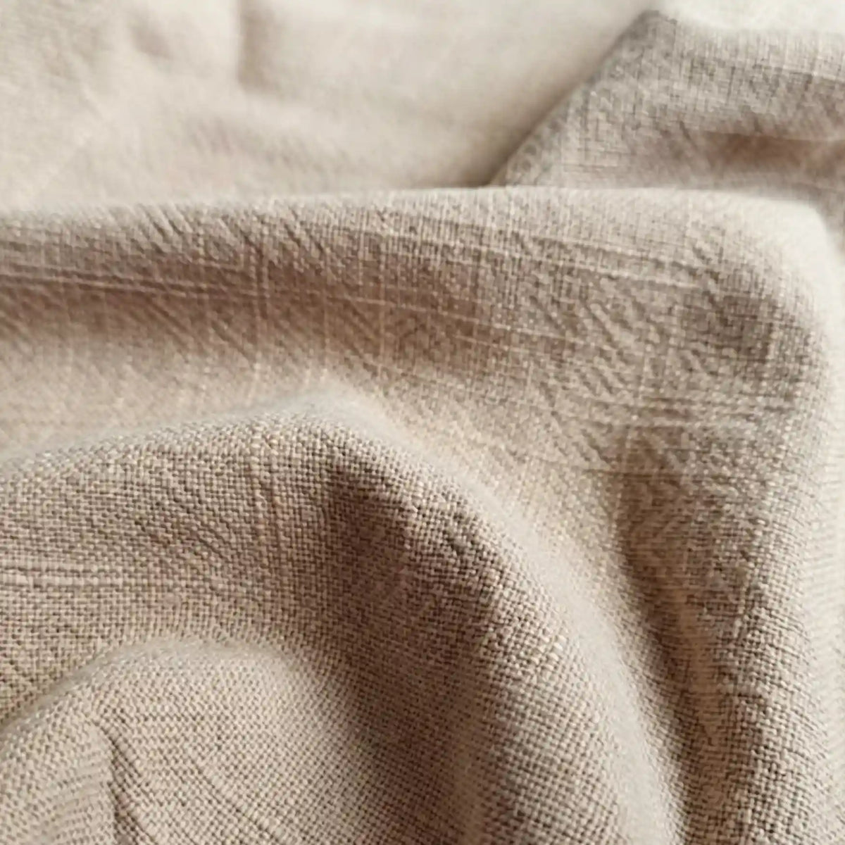 A close-up of Longan Craft's Solid Color Rayon Linen Fabric by the yard shows its soft, textured slub viscose surface with visible woven patterns and gentle folds, ideal for dresses and clothing.