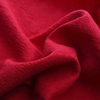 Close-up of Longan Craft's Solid Color Rayon Linen Fabric By The Yard, a thick washed slub viscose material with a soft, textured surface and visible folds, perfect for dresses and clothing projects.